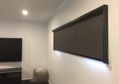 Black roller blind closed.