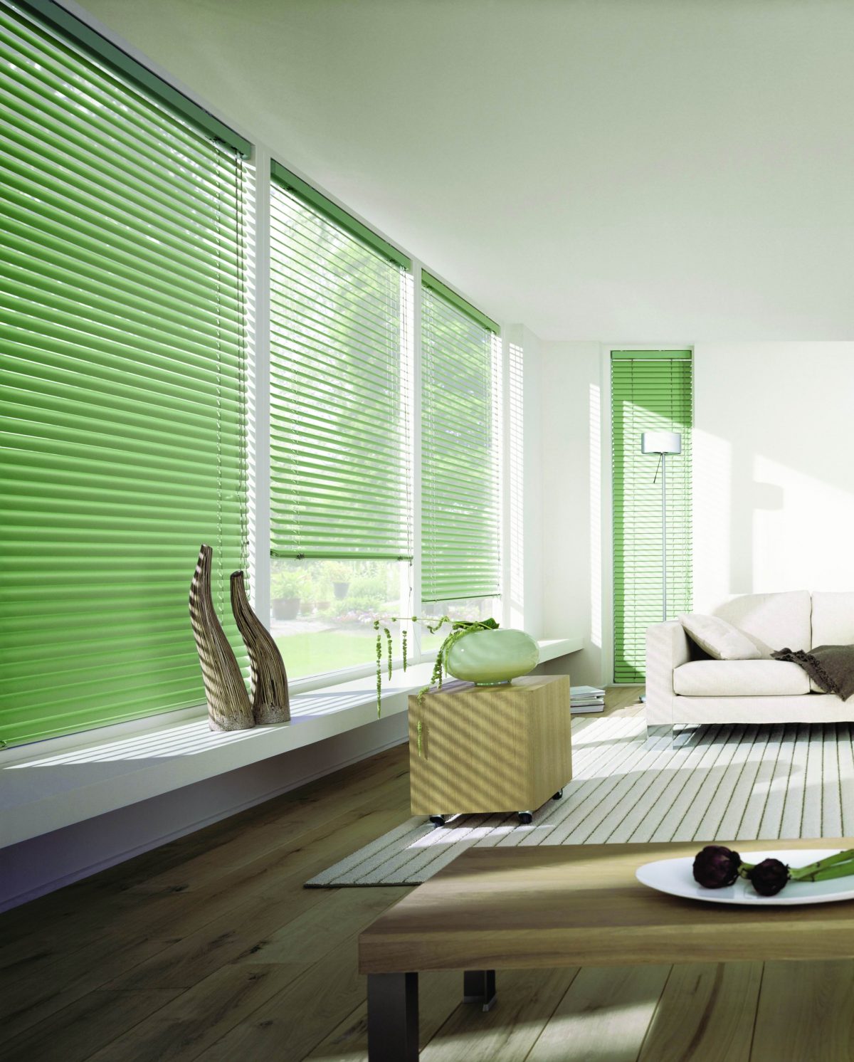 Aluminium-Venetian-Blinds A living room area with green aluminium venetian blinds.