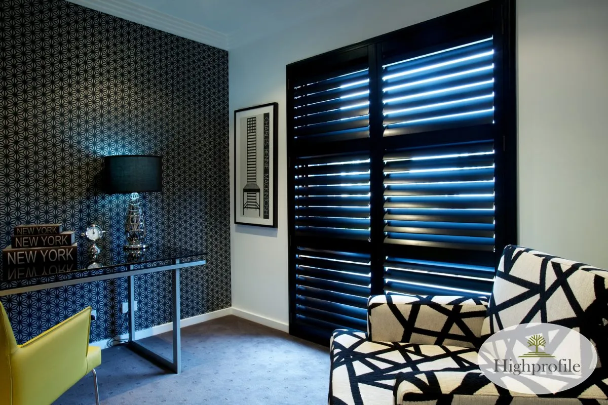 highprofile-black-hinged-timberplantationshutter01 Hotel room with black timber plantation shutters.